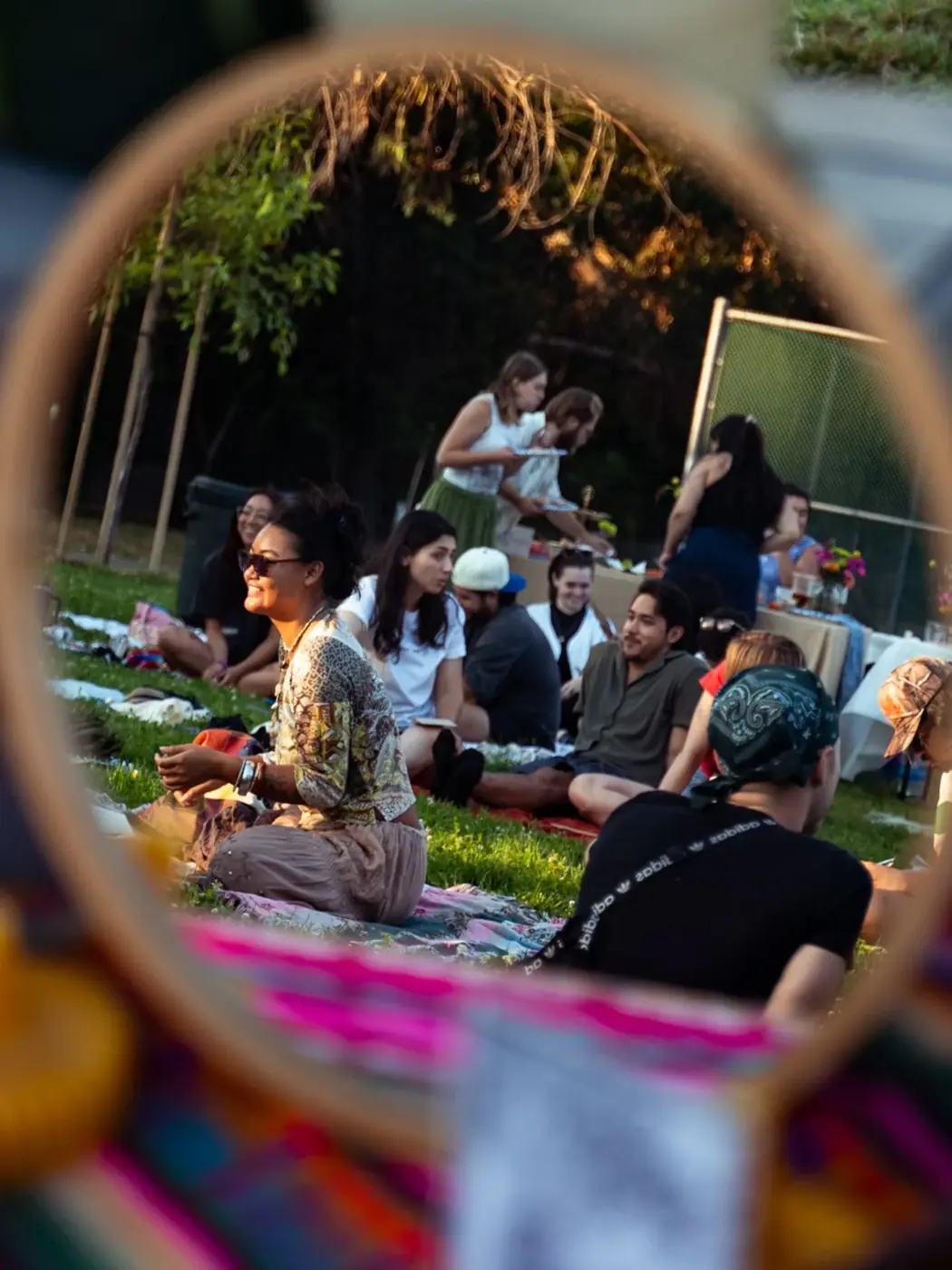 A gathering seen through a colorful circular ribbon