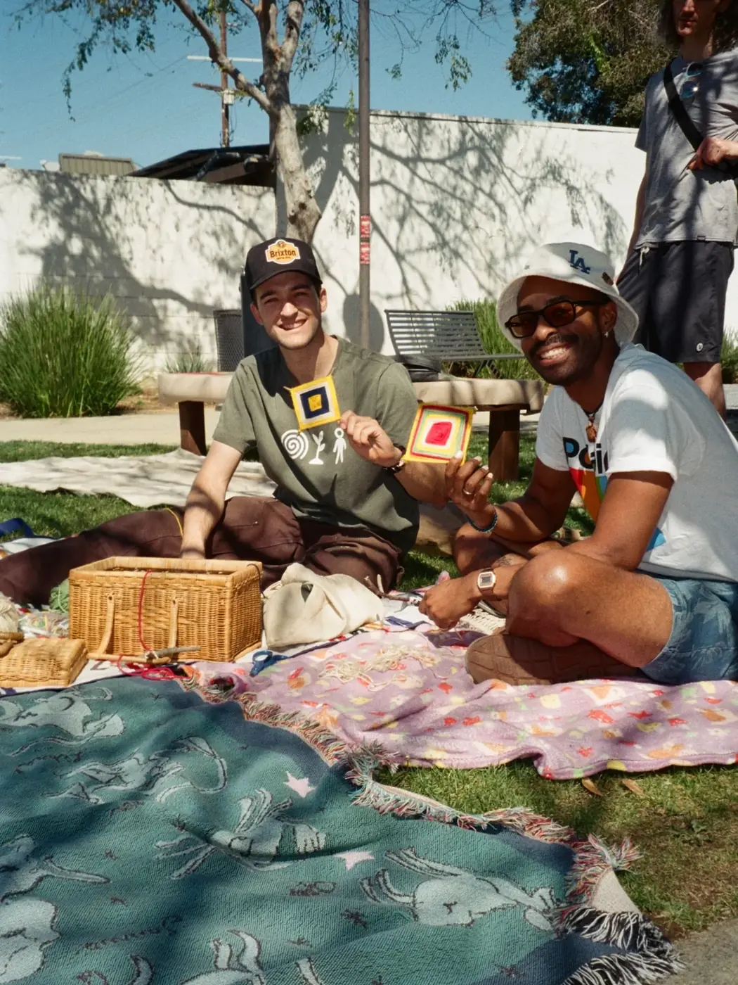 People sharing food and conversation on a picnic blanket