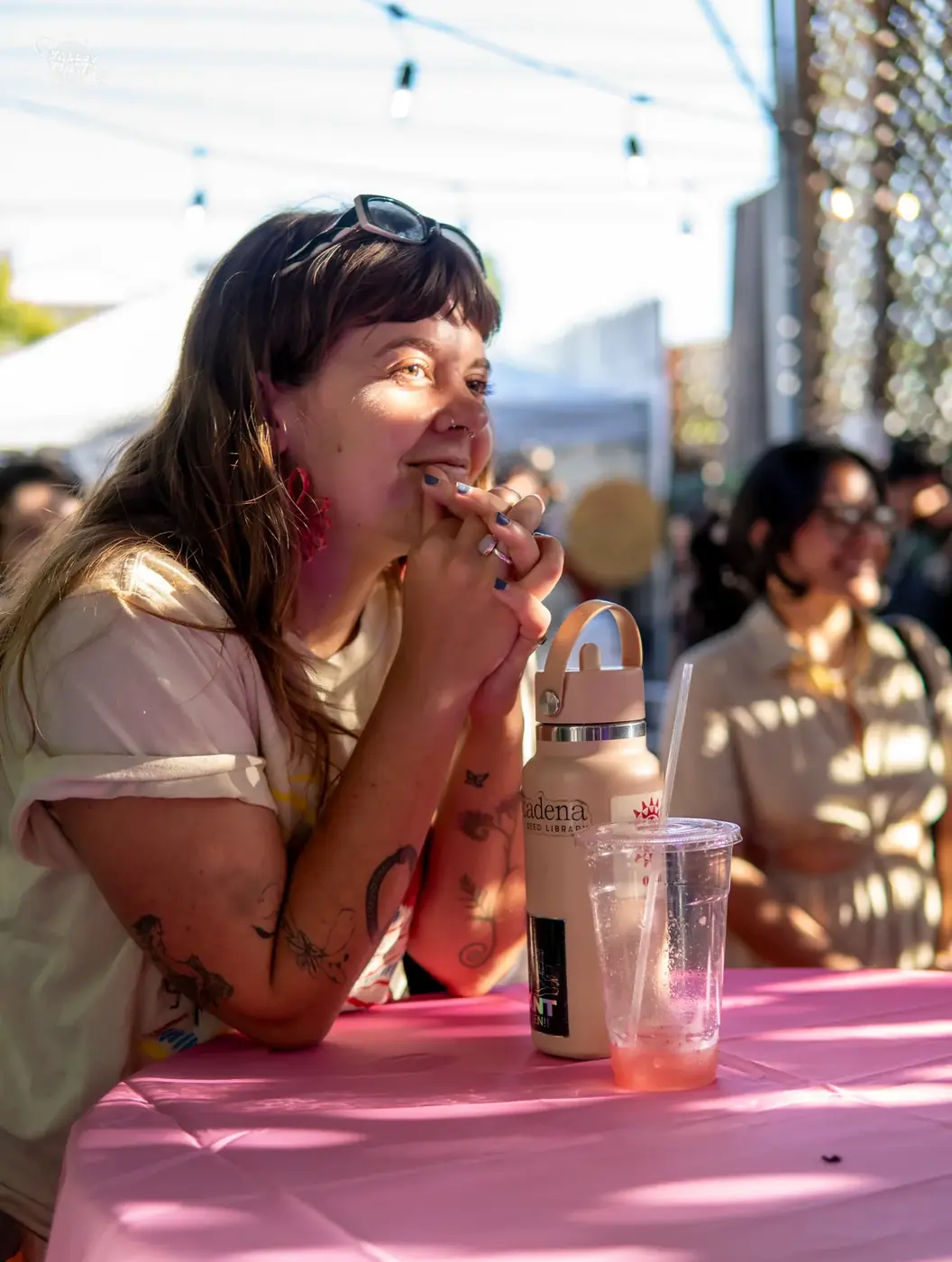 A community member singing at an outdoor table