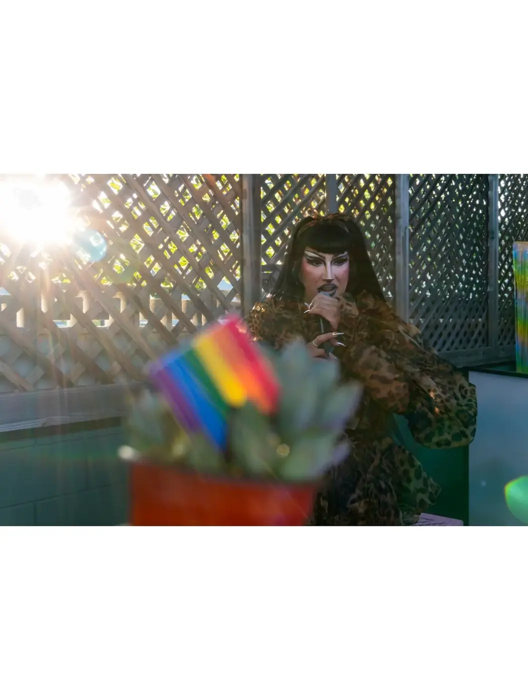 A person holding a rainbow reflection in sunlight